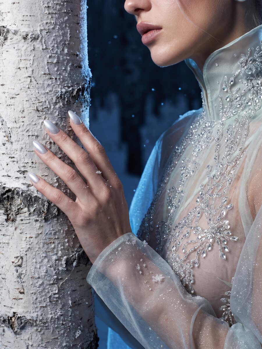 AI fashion detail: crystal embroidery and a hand on a frosted birch